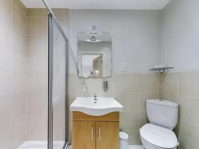 a bathroom with a toilet and a sink and a shower at Pearl Suite in Blackpool
