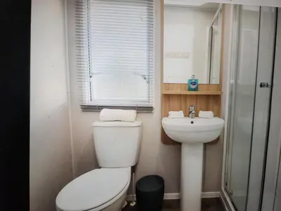 a small bathroom with a toilet and a sink at 32 Bayview Oceans Edge in Morecambe