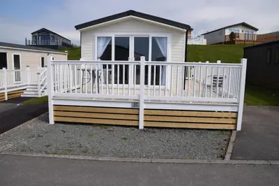 a house with a white railing and a porch at 32 Bayview Oceans Edge in Morecambe