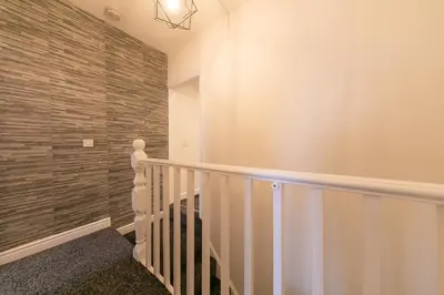 a staircase in a house with a brick wall at Stunning house near Blackpool attractions in Blackpool