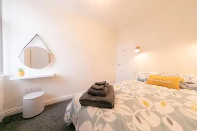 a bedroom with a bed and a mirror on the wall at Stunning house near Blackpool attractions in Blackpool
