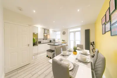 a kitchen and dining room with a table and chairs at Stunning house near Blackpool attractions in Blackpool