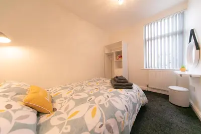 a bedroom with a bed and a window at Stunning house near Blackpool attractions in Blackpool