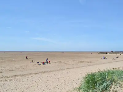 a group of people on a sandy beach at Honeybee Cottage in Lytham St Annes