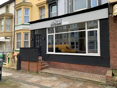 a store front of a building with a window at Urban Inn in Blackpool