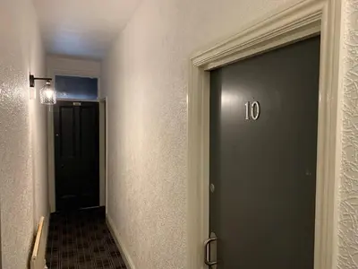 a hallway with a door with the number on it at Urban Inn in Blackpool