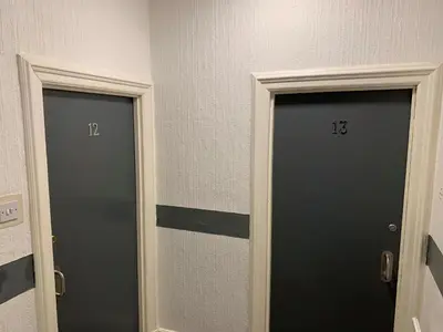 two doors with numbers on them in a room at Urban Inn in Blackpool