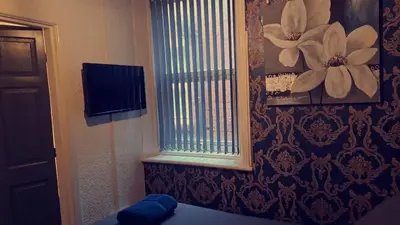 a room with a window with a flower on the wall at Urban Inn in Blackpool