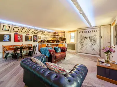 a living room with a couch and a table at The Artist Studio in Hest Bank
