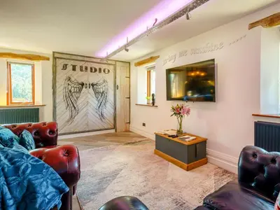 a living room with a couch and a table at The Artist Studio in Hest Bank