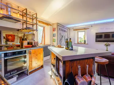 a kitchen with a counter and a stove top oven at The Artist Studio in Hest Bank