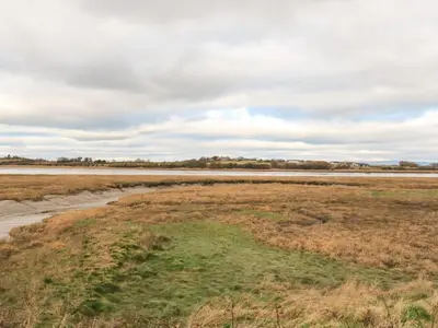 an open field with a body of water at Hope Cottage in Hambleton