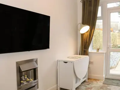 a living room with a flat screen tv on a wall at Hope Cottage in Hambleton