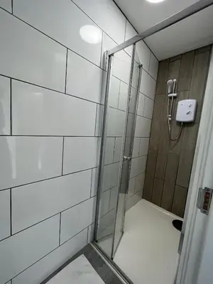 a shower with a glass door in a bathroom at Modern 1 bed studios for comfy stay in Preston in Preston