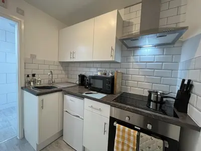 a kitchen with a sink and a microwave at Modern 1 bed studios for comfy stay in Preston in Preston