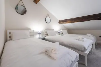 two white beds with towels on them in a room at RST Bramley Moore in Liverpool