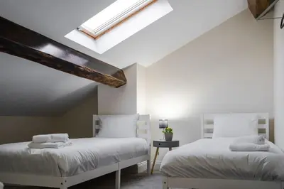 a bedroom with two beds and a skylight at RST Bramley Moore in Liverpool