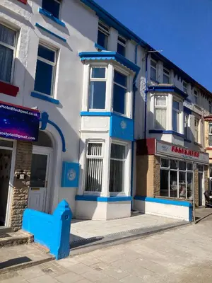 a blue and white building on a city street at The New Apollo Hotel in Blackpool