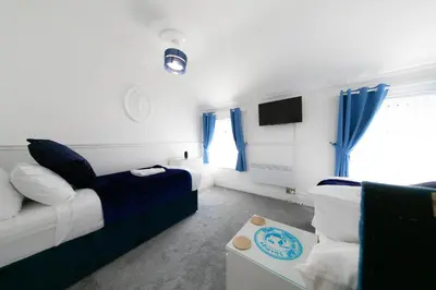 a living room with a bed and a couch at The New Apollo Hotel in Blackpool