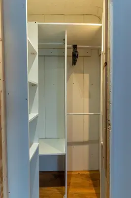 a closet with white shelves and a glass door at Cheerful and modern 3 BDR for 7 in Liverpool
