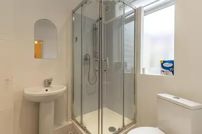 a bathroom with a shower and a sink and a toilet at Cheerful and modern 3 BDR for 7 in Liverpool