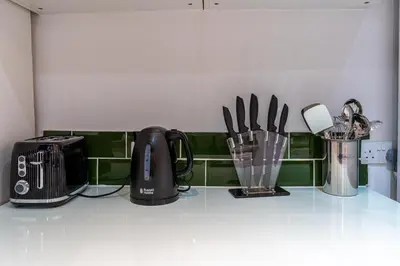a kitchen counter with appliances on a counter top at Cheerful and modern 3 BDR for 7 in Liverpool