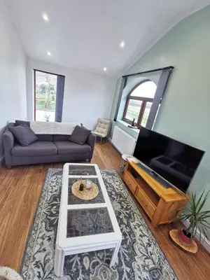 a living room with a couch and a table at The Bakery in Pilling