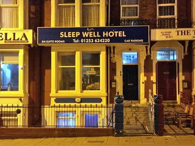 a building with a sign for a sleep well hotel at Sleep Well Hotel in Blackpool