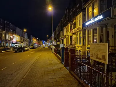 a city street at night with a street light at Sleep Well Hotel in Blackpool