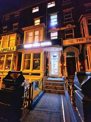 a building with a staircase leading to a door at Sleep Well Hotel in Blackpool