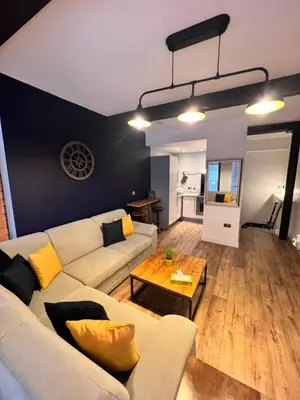 a living room with a couch and a table at Stunning Liverpool City Center Apartment in Liverpool