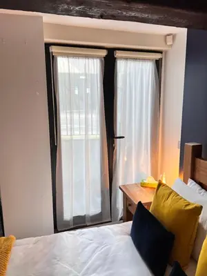 a bedroom with a bed and a large window at Stunning Liverpool City Center Apartment in Liverpool
