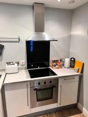 a kitchen with a stove top oven in a kitchen at Stunning Liverpool City Center Apartment in Liverpool