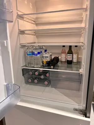 an open refrigerator filled with bottles and drinks at Stunning Liverpool City Center Apartment in Liverpool