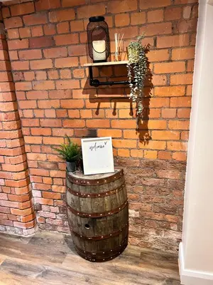 a brick wall with a barrel with a sign on it at Stunning Liverpool City Center Apartment in Liverpool