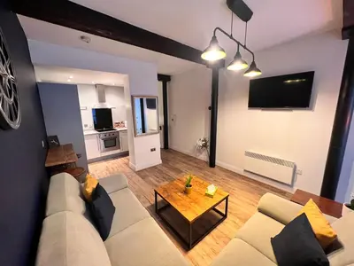 a living room with a couch and a table at Stunning Liverpool City Center Apartment in Liverpool