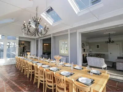 a long dining room with a long table and chairs at Valley View in Dalton in Furness