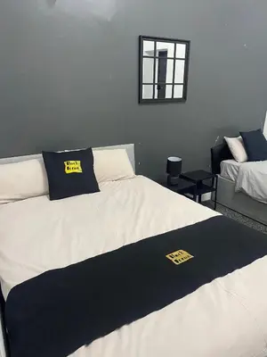 a bedroom with two beds and a window at Black Ocean Holiday Apartments in Blackpool