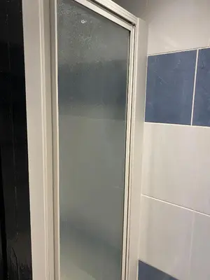 a glass shower door in a bathroom at Black Ocean Holiday Apartments in Blackpool