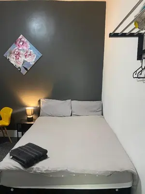 a bedroom with a bed with a black towel on it at Black Ocean Holiday Apartments in Blackpool