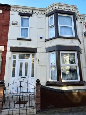 a white house with a fence in front of it at Watford Road House Liverpool in Liverpool