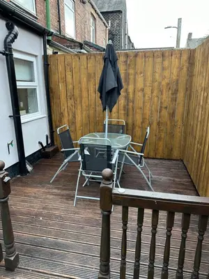 a patio with a table and chairs and an umbrella at Watford Road House Liverpool in Liverpool