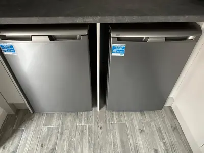 two refrigerators sitting under a counter in a kitchen at Watford Road House Liverpool in Liverpool