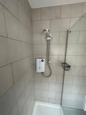 a bathroom with a shower with a shower head at Watford Road House Liverpool in Liverpool