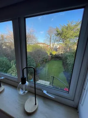 a window with a view of a golf course at Garden by the Bay Southport in Southport