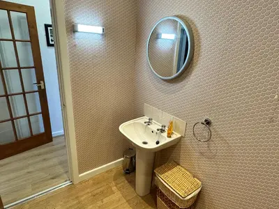 a bathroom with a sink and a mirror on the wall at Spacious one bedroom apartment in central location in Lytham St Annes