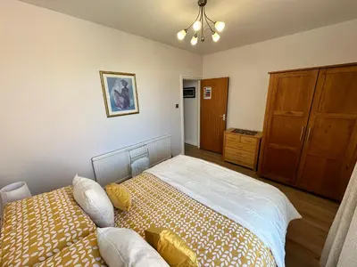 a bedroom with a bed and a dresser at Spacious one bedroom apartment in central location in Lytham St Annes