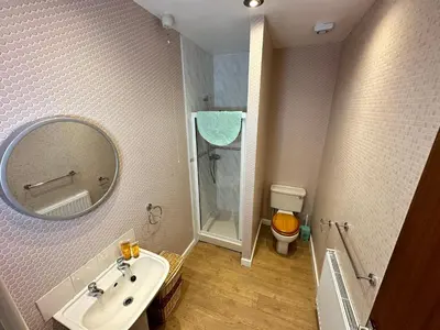 a bathroom with a sink and a toilet and a mirror at Spacious one bedroom apartment in central location in Lytham St Annes