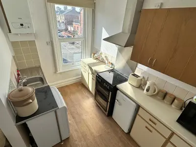 a kitchen with a sink and a stove top oven at Spacious one bedroom apartment in central location in Lytham St Annes