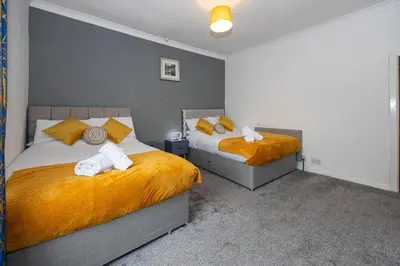 a bedroom with two beds with towels on them at Cosy Two bedroom Terrace Blackburn in Cherry Tree